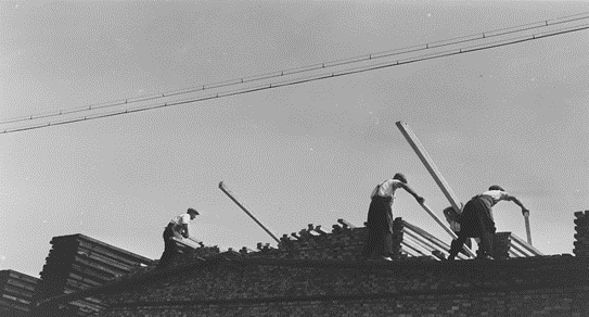 Surrey Docks, stacking timber from the temporary walkway, 1932.  X..png