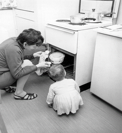 Anchor Street. Gas at Pope House on the Manor Estate 1968, all appliances having now changed to electric power Mrs Christine Dedman, and her daughter Sheila, get the first meal ready.   X..png