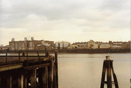 Upper Globe Wharf left, Lower King & Queen Wharf right of Tanks, Amos Estate in the distance c1980.  X.png