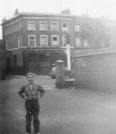 Long Lane c1957. Peter Leaver in the entrance to Dunkirk House, The Valentine Pub is opposite, Weston Place is left of the pub.  X..png