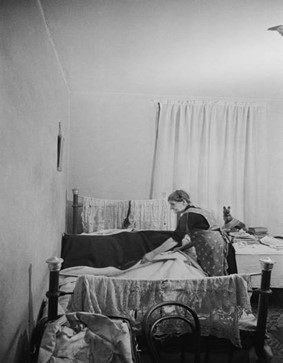 Christmas Street, a pensioner makes her bed at home in Christmas Street, December 1946. X..jpg