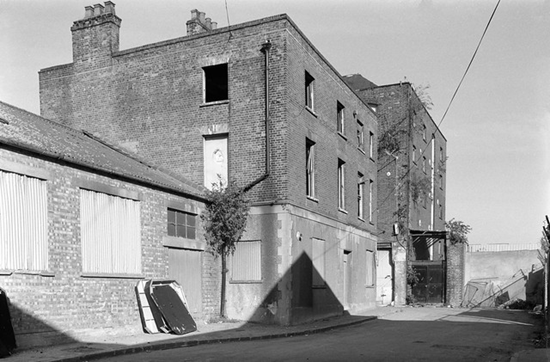 Bermondsey Wall, warehouses of Vestry Wharf, beyond it, East Lane Wharf  c1988.  X..png