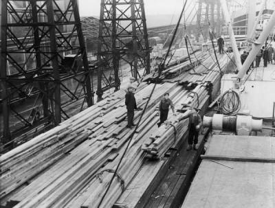 Surrey Commercial Docks,Rotherhithe. Wood unloaded from the Pacific Reliance (1951).  X.png