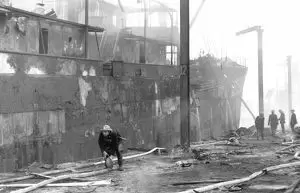Surrey Commercial Docks, severely damaged cargo ship after being engulfed by the fires caused by heavy bombing raids during the Second World War.  X.png